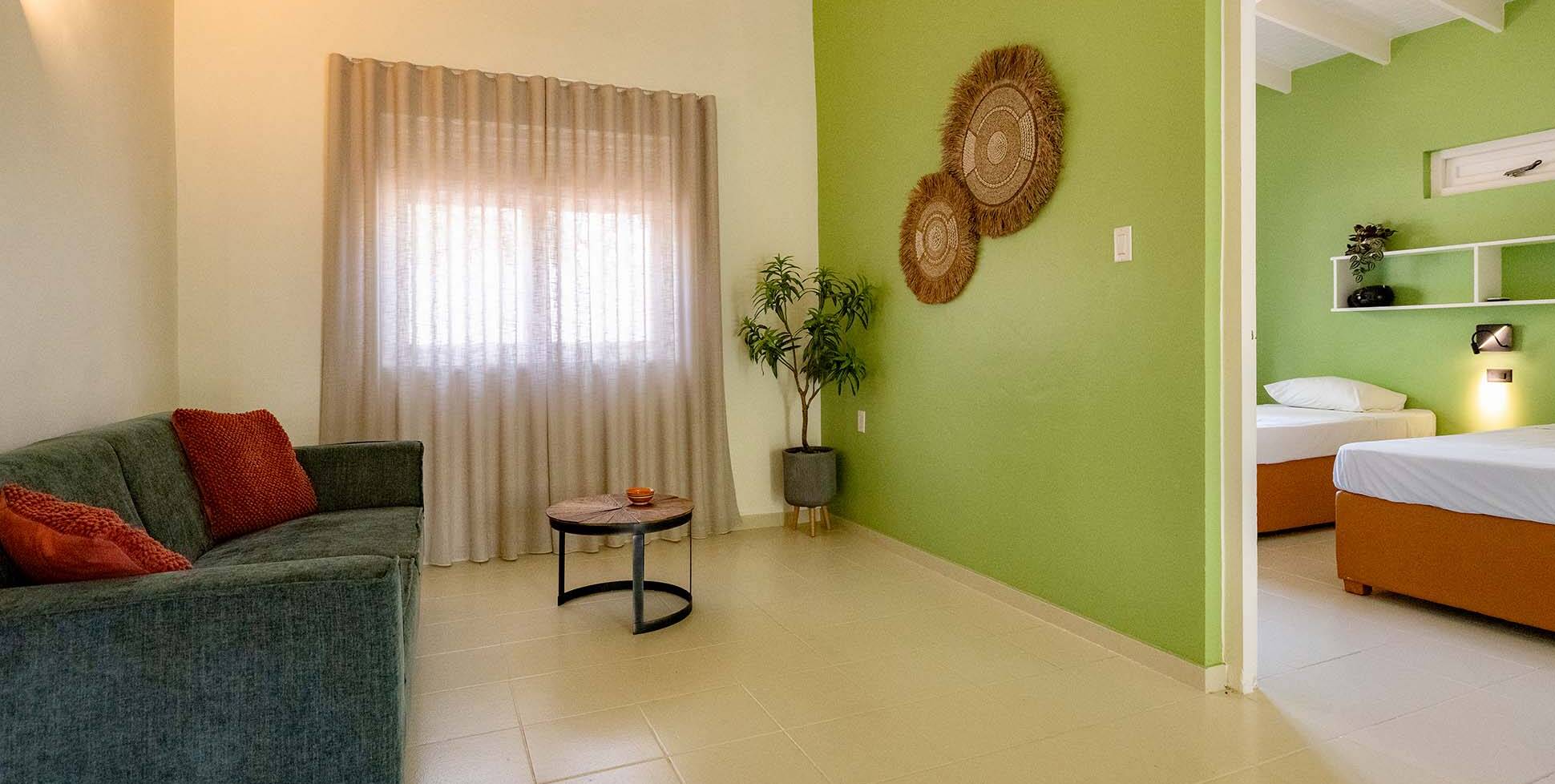 Dream of the Green Flamingo | Curacao Holiday Park - two bedroom apartment bungalow - living room coach